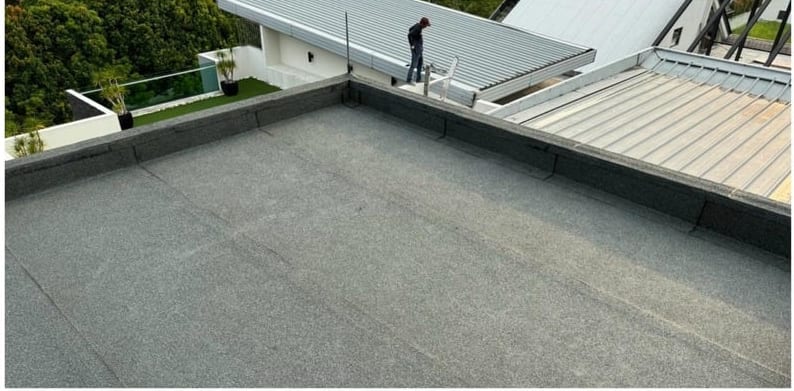 The roof finished in dark granular membrane.